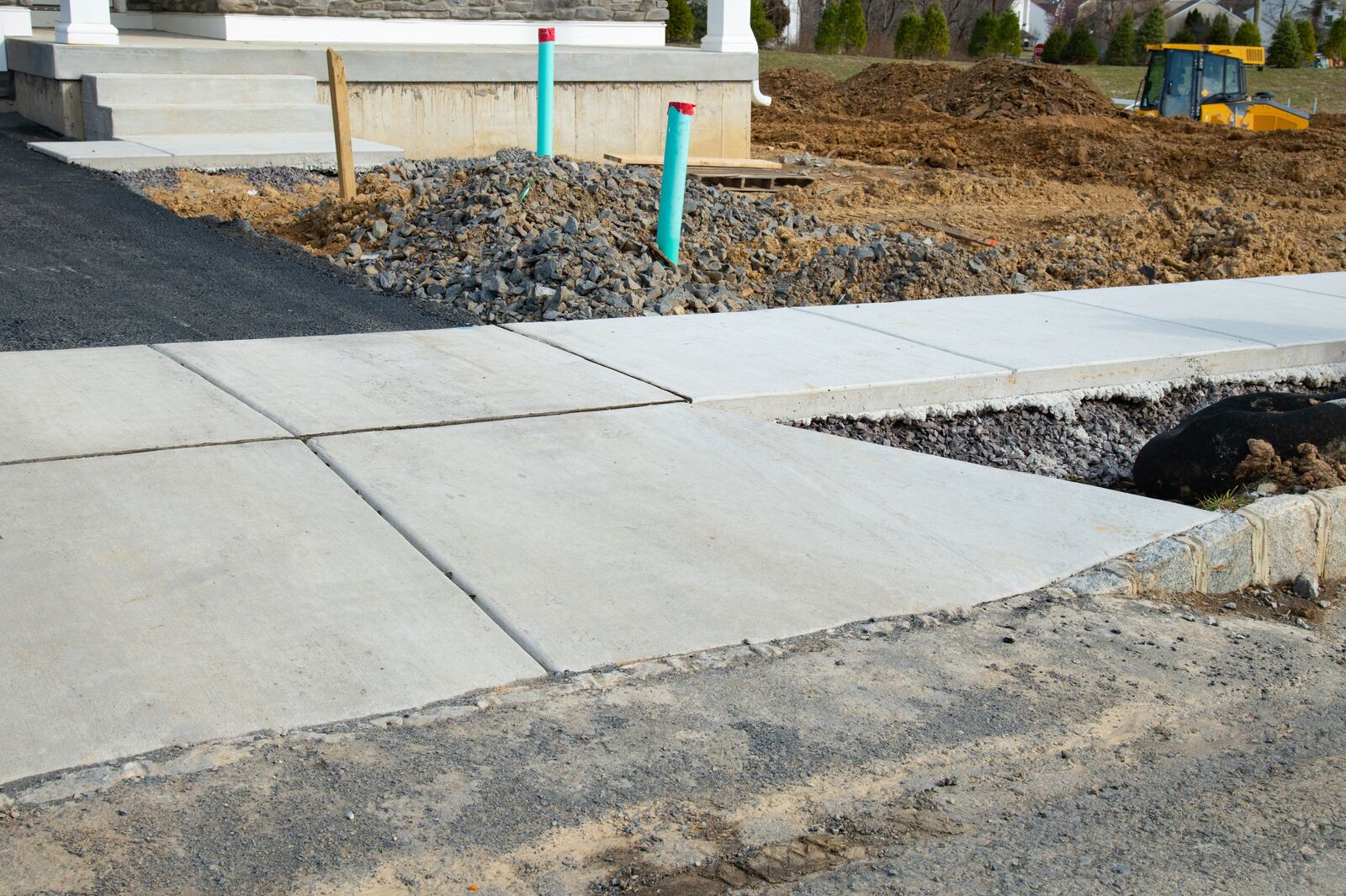 New concrete sidewalk and curb ramp at a commercial site