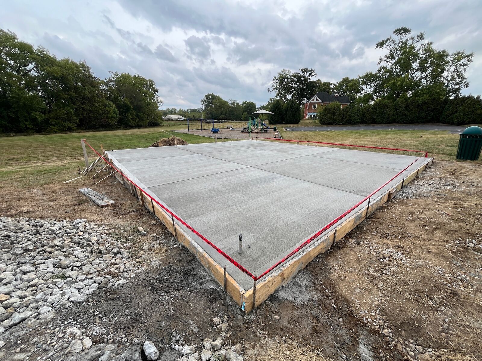 Finished reinforced concrete equipment slab with saw-cut joints inside forms