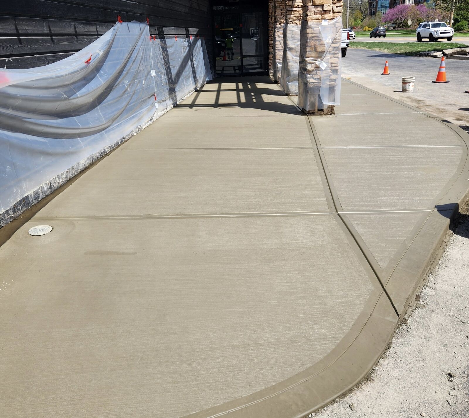 New concrete sidewalk and curb at a commercial entrance
